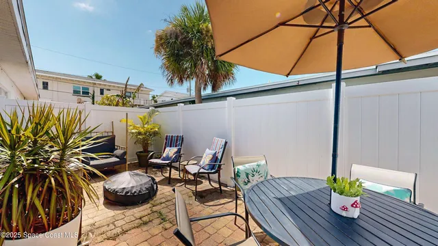 a spacious bedroom with a large bed and a chandelier