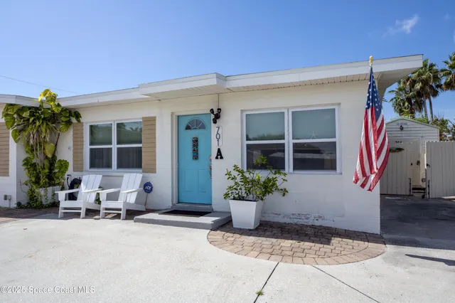 a view of hallway with furniture and wooden floor