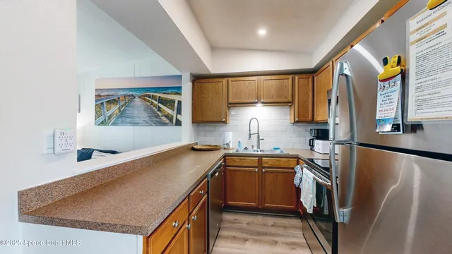 a bedroom with a bed and a flat tv screen on dresser