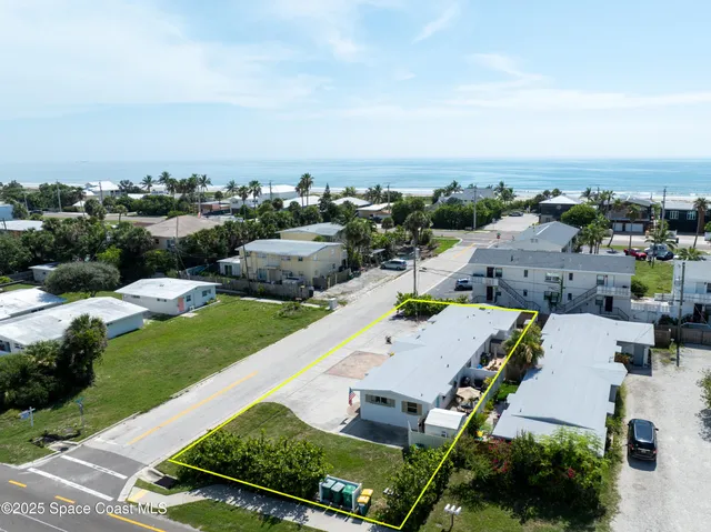 an aerial view of a house with a garden and lake view