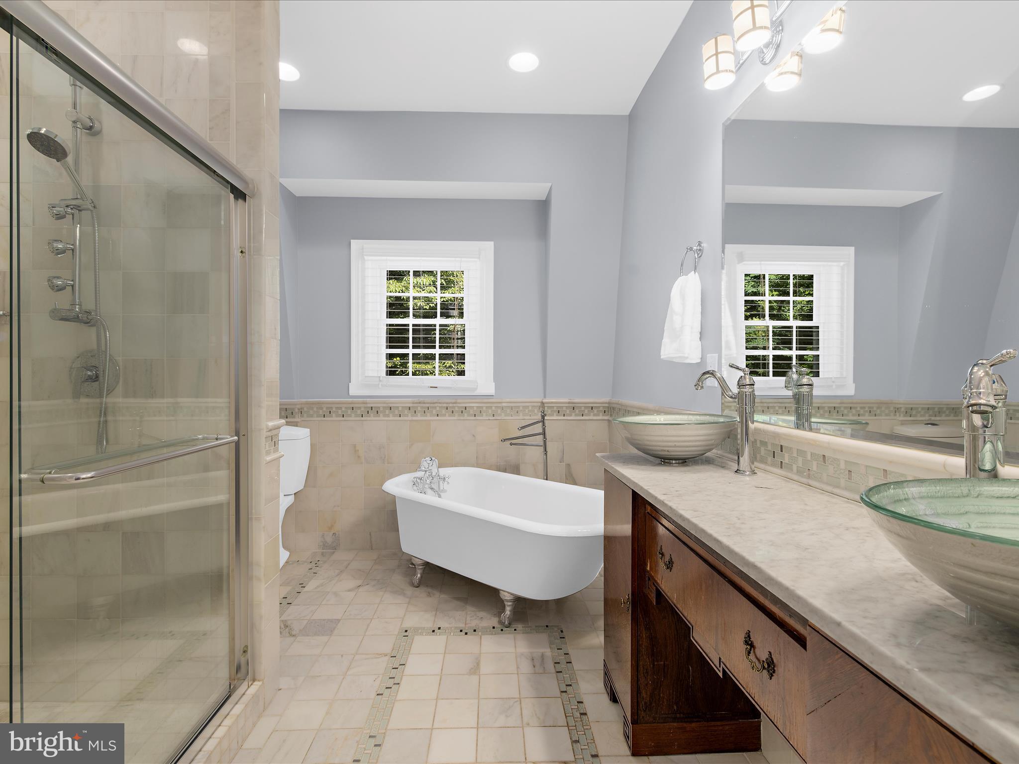 16 Elmwood Road Baltimore, MD 21210 - Photo 34 of 79 a spacious bathroom with a tub sink and mirror