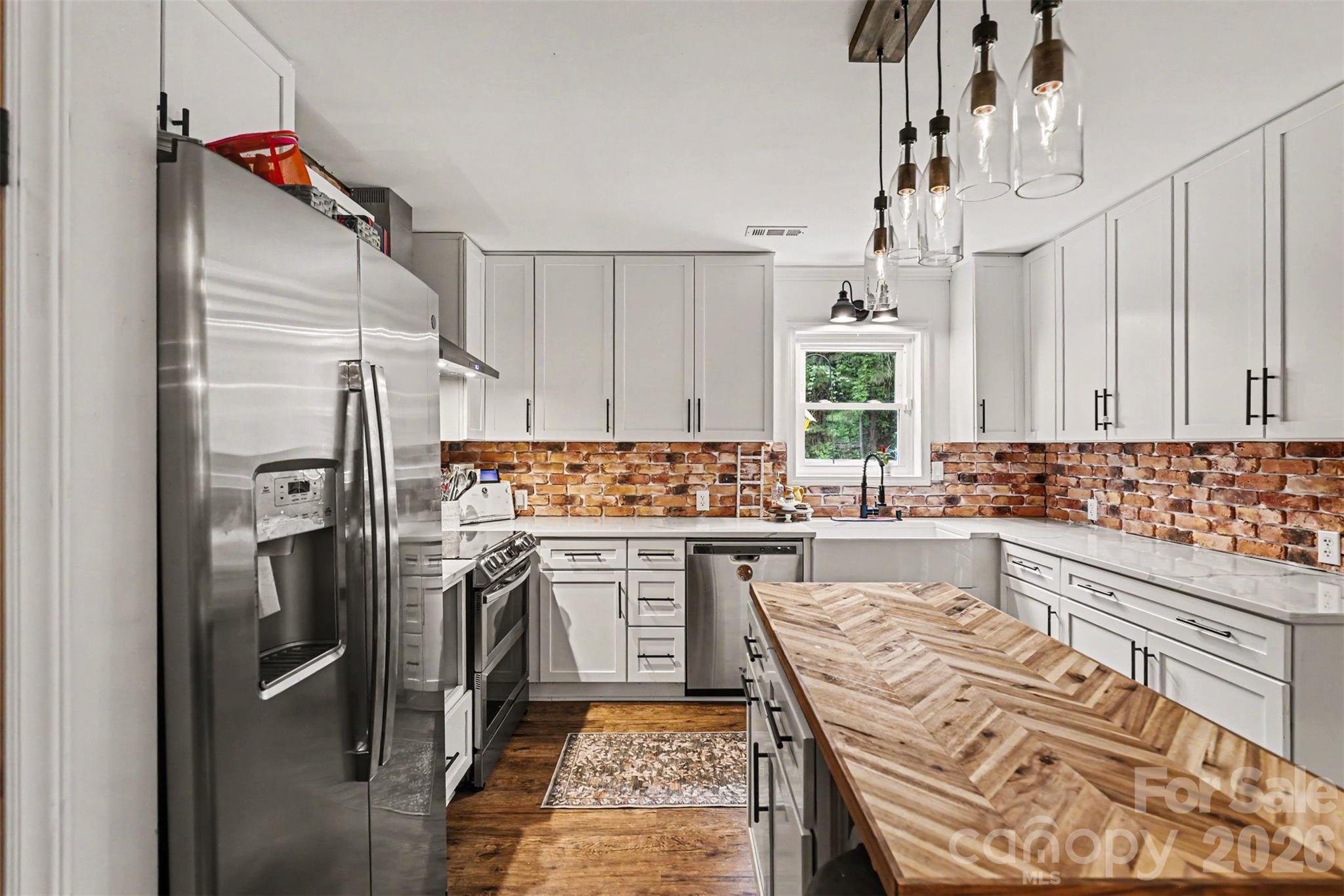 184 Canal Road Belmont, NC 28012 - Photo 25 of 39 a kitchen with a refrigerator and white cabinets