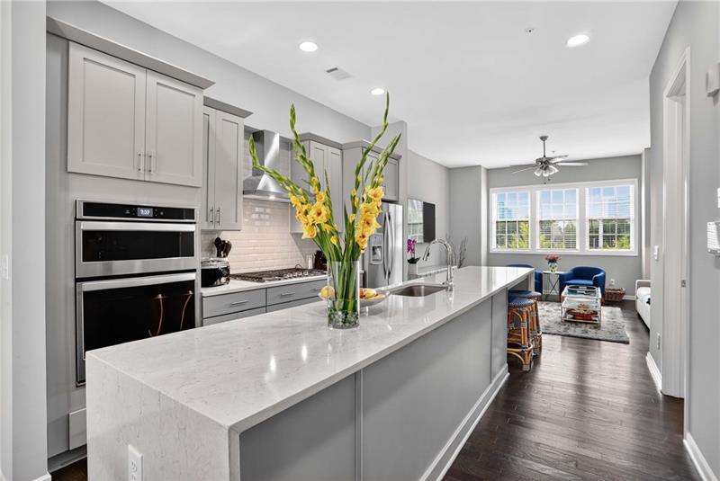 a kitchen with stainless steel appliances a sink stove and cabinets