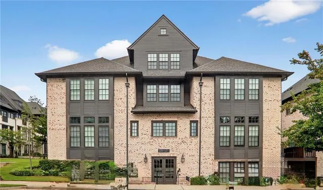 front view of a brick house with a small yard