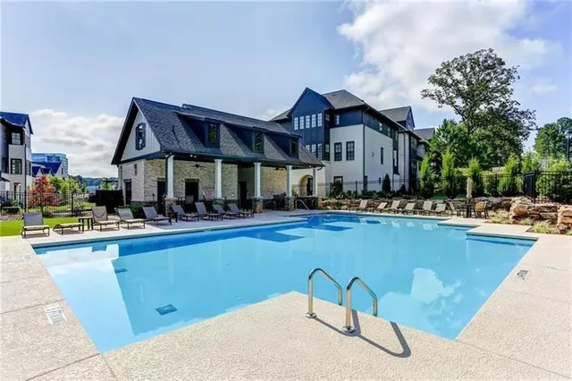a view of a house with swimming pool and sitting area