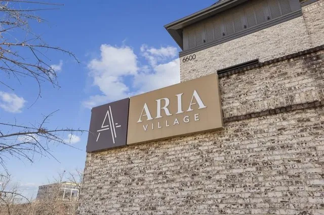 a sign broad in front of a brick building