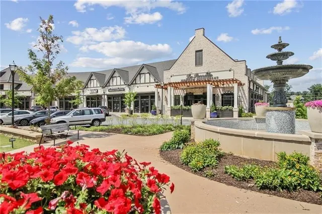 a front view of multiple houses with yard