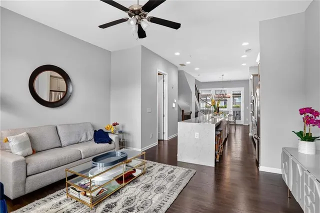 a living room with furniture and a wooden floor