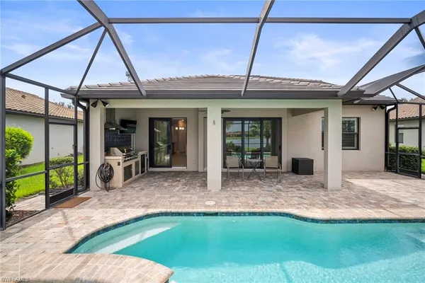 a view of a house with backyard porch and sitting area