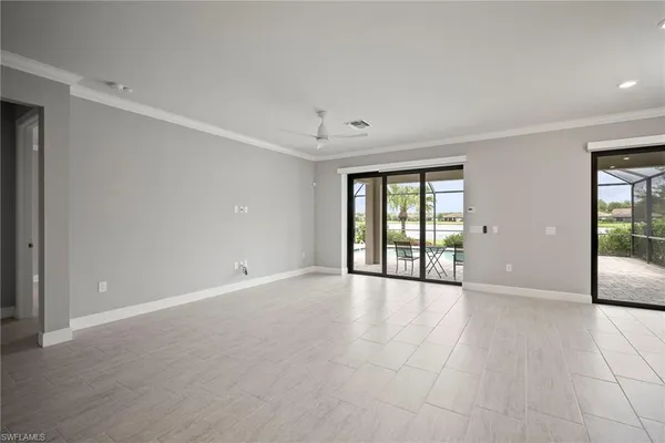 a view of an empty room with glass door and balcony