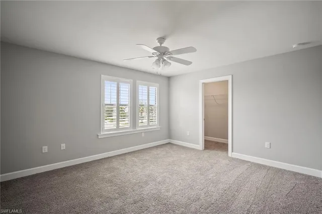 a bathroom with a granite countertop sink a toilet a mirror and bathtub