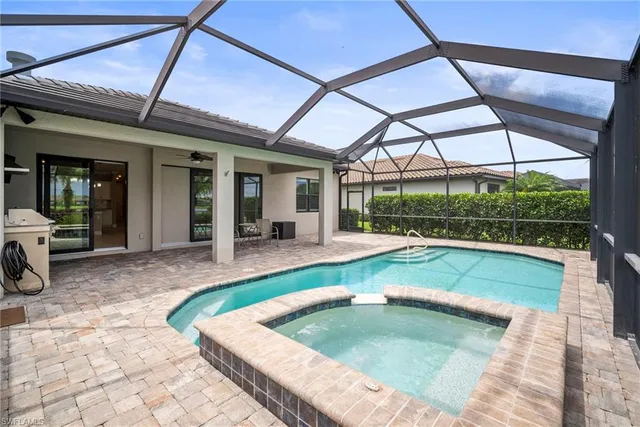 a view of a patio with a table and chairs under an umbrella