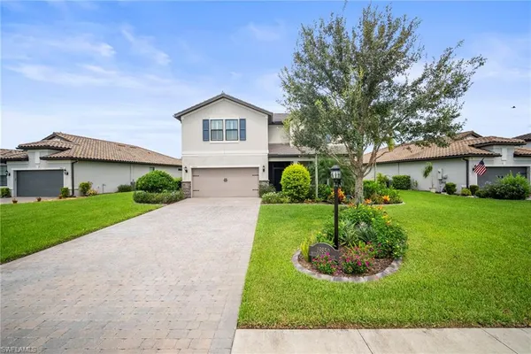 a front view of a house with a yard and garage