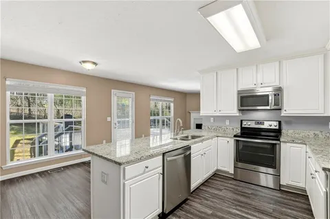 a kitchen with stainless steel appliances granite countertop a stove and a sink