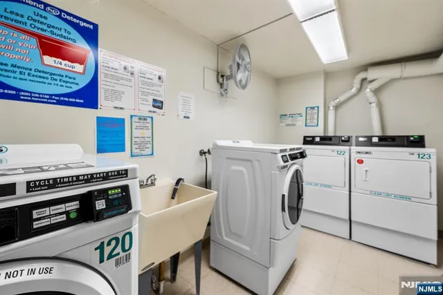a living room with a black white checkered floor with couches chair and a coffee table