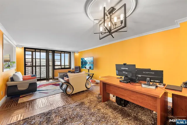 a living room with furniture and floor to ceiling windows