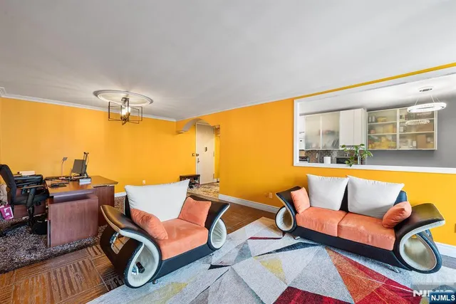 a living room with furniture and a floor to ceiling window