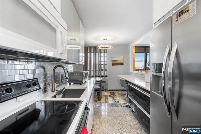 a bedroom with a bed and a television