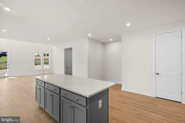 an empty room with wooden floor and window