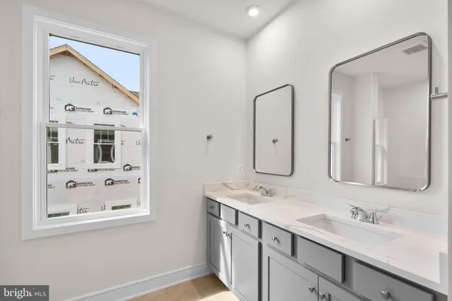a bathroom with a double vanity sink mirror and