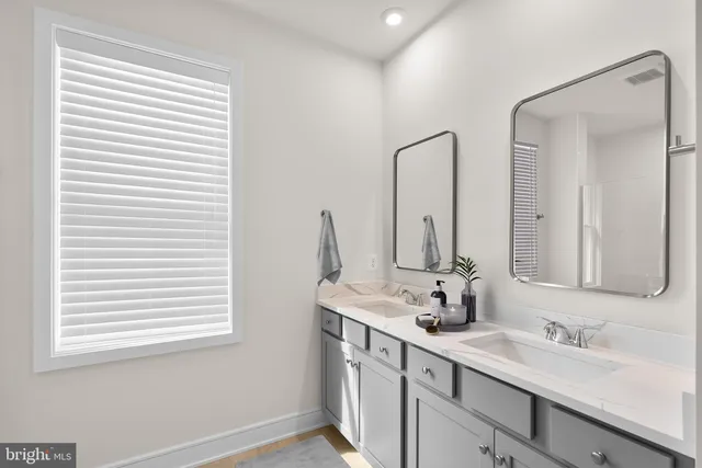 a bathroom with a double vanity sink and a mirror