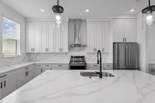 a kitchen with kitchen island a counter top space appliances and cabinets