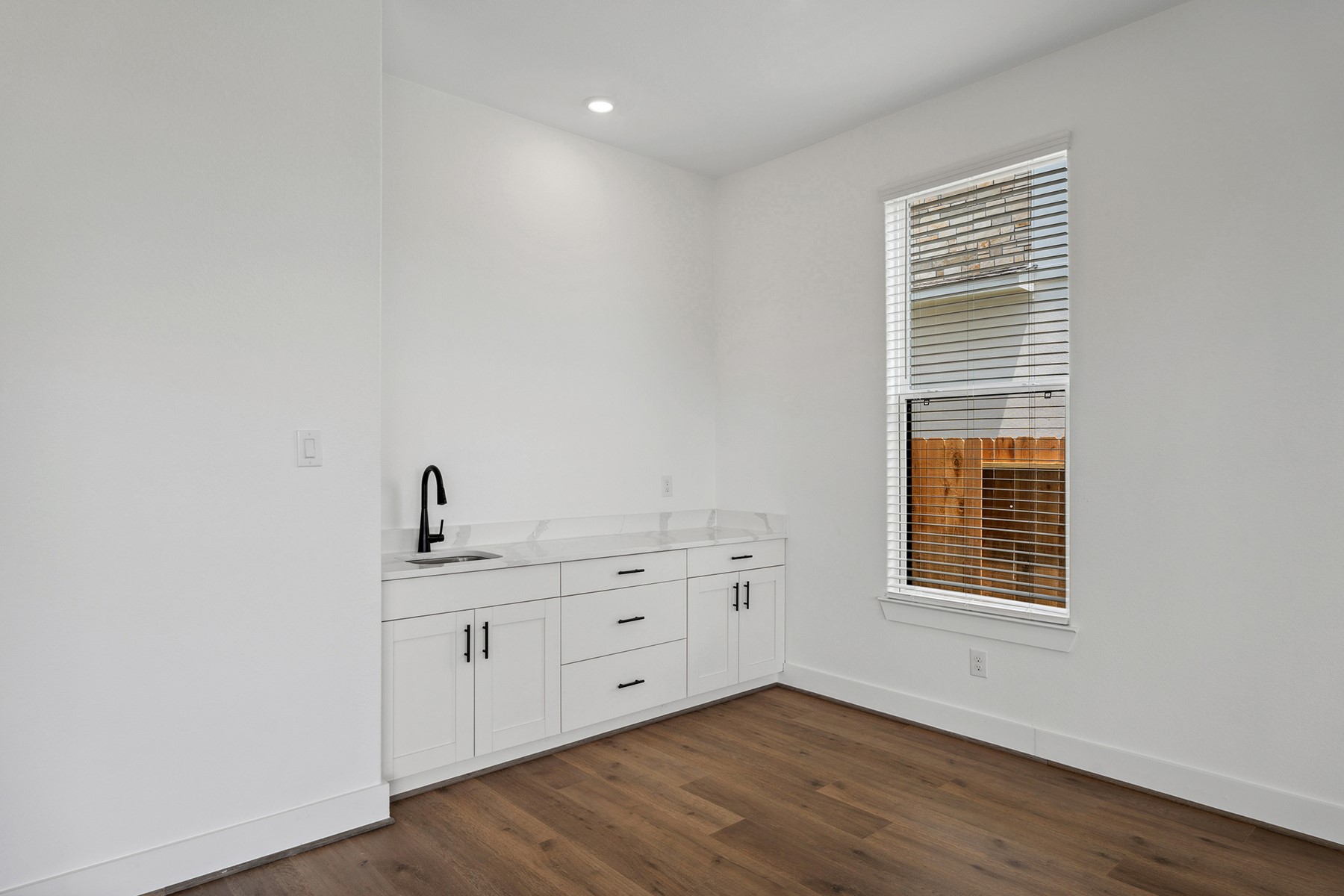 1820 Drover Lane Rosenberg, TX 77471 - Photo 14 of 25 a view of a kitchen with wooden floor and windows