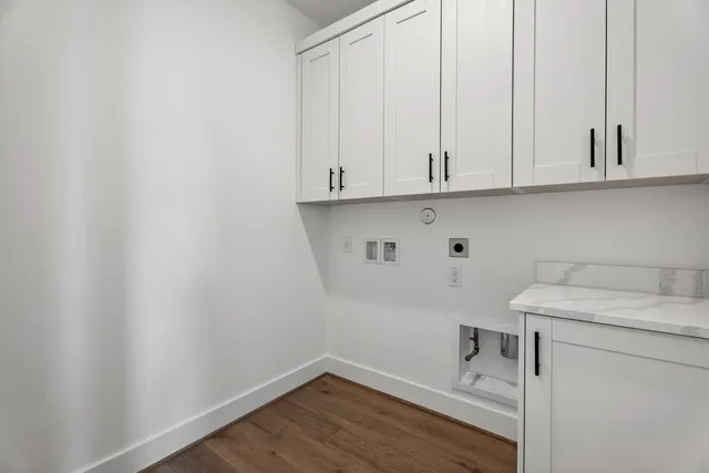 a view of storage and utility room with wooden floor