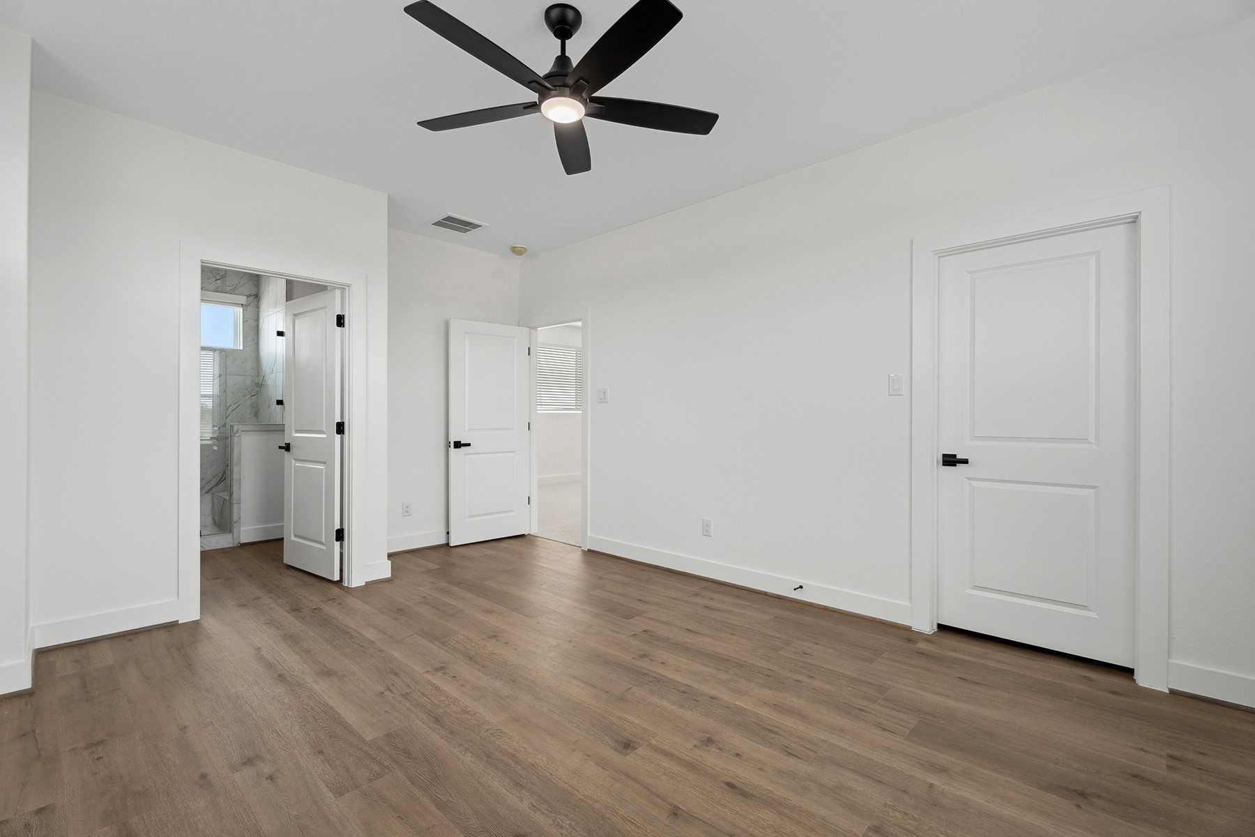 1820 Drover Lane Rosenberg, TX 77471 - Photo 21 of 25 an empty room with wooden floor closet and windows