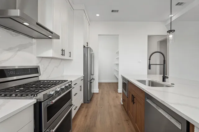a kitchen with a sink and stainless steel appliances