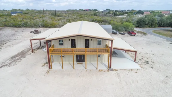 an aerial view of a house with a yard and garage