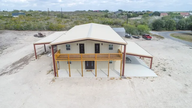 an aerial view of a house with a yard and garage