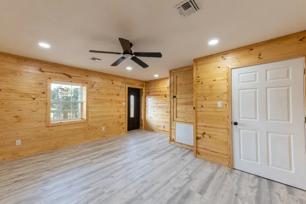 a view of a balcony with wooden floor and windows