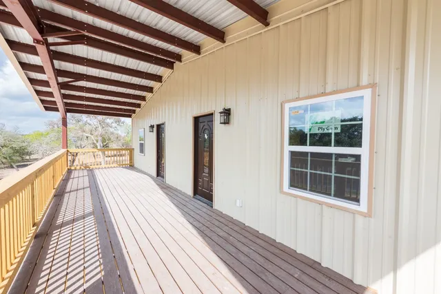 a view of balcony with wooden floor