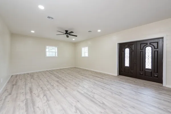 a kitchen with stainless steel appliances granite countertop a refrigerator a stove and a sink