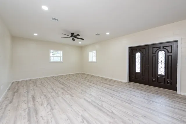 a kitchen with stainless steel appliances granite countertop a refrigerator a stove and a sink