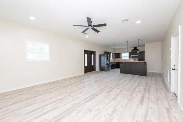 a kitchen with stainless steel appliances granite countertop a refrigerator and a stove top oven