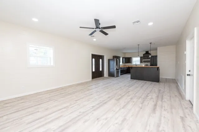 a kitchen with stainless steel appliances granite countertop a refrigerator and a stove top oven