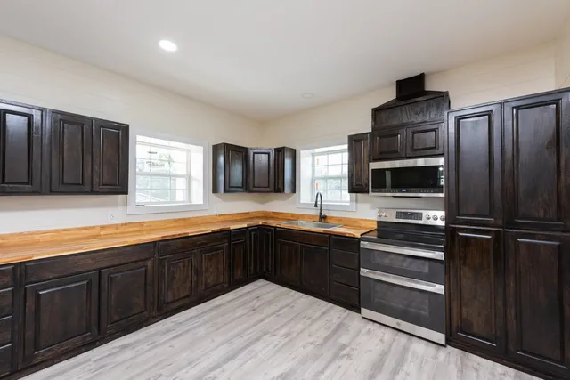 a kitchen with a refrigerator and a sink
