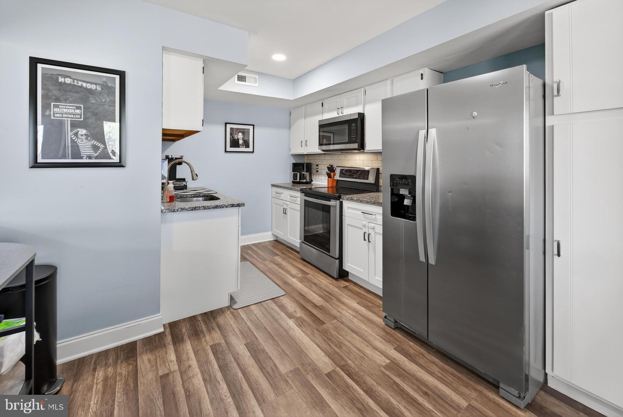 115 East Kings Highway, Unit 360 Maple Shade, NJ 08052 - Photo 12 of 20 a kitchen with stainless steel appliances a refrigerator and a stove top oven