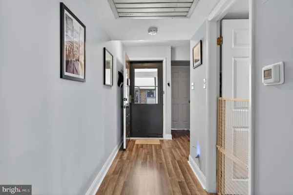 a view of hallway with wooden floor