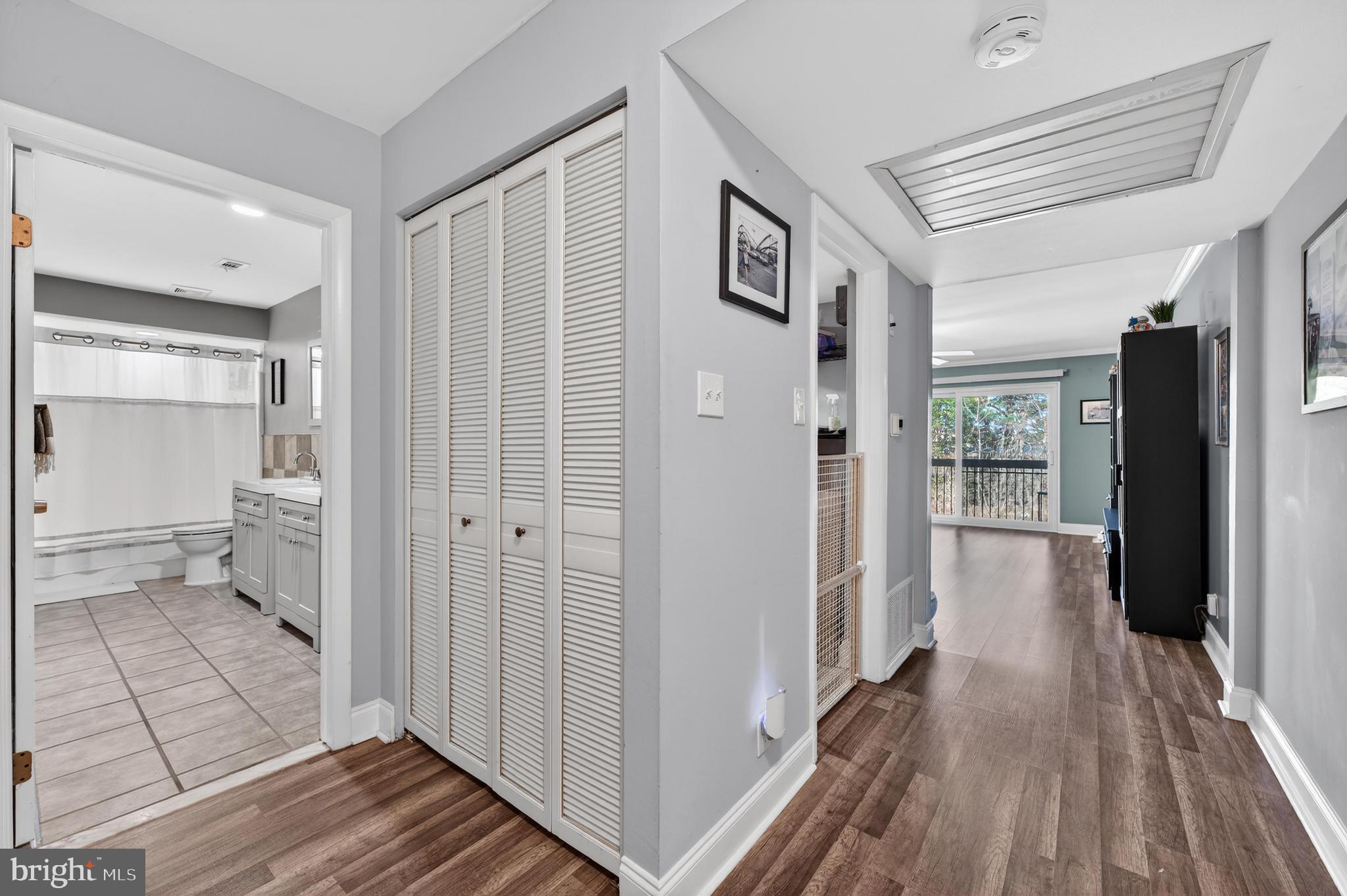 115 East Kings Highway, Unit 360 Maple Shade, NJ 08052 - Photo 4 of 20 a view of a hallway with wooden floor and a bathroom