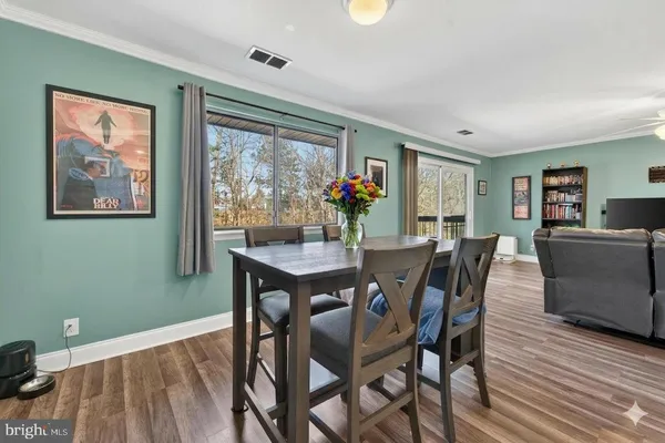 a view of a dining room with furniture window and wooden floor
