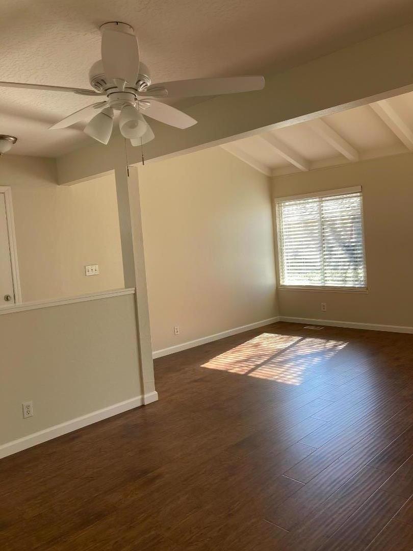 1010 Bryant Way, Unit E Sunnyvale, CA 94087 - Photo 11 of 13 an empty room with wooden floor fan and windows