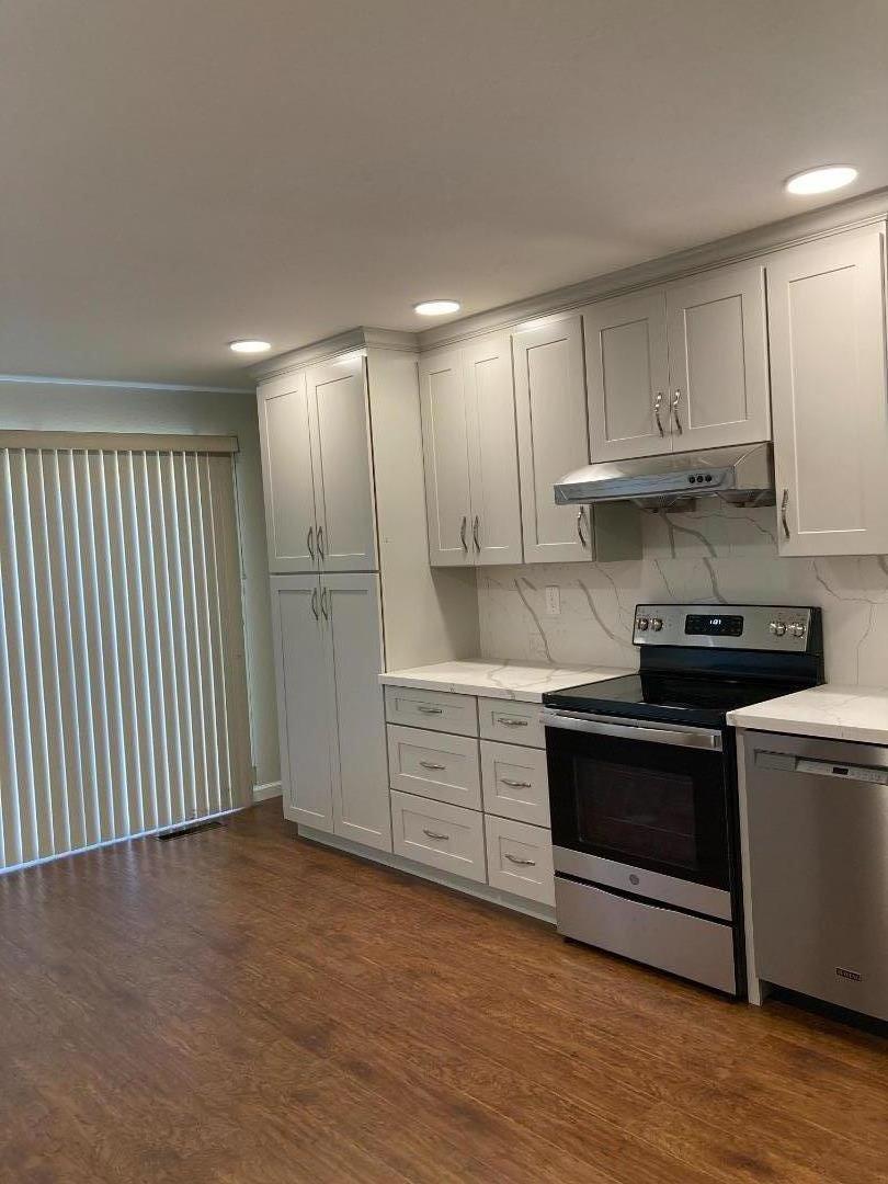 1010 Bryant Way, Unit E Sunnyvale, CA 94087 - Photo 12 of 13 a kitchen with stainless steel appliances granite countertop a stove a sink and a refrigerator