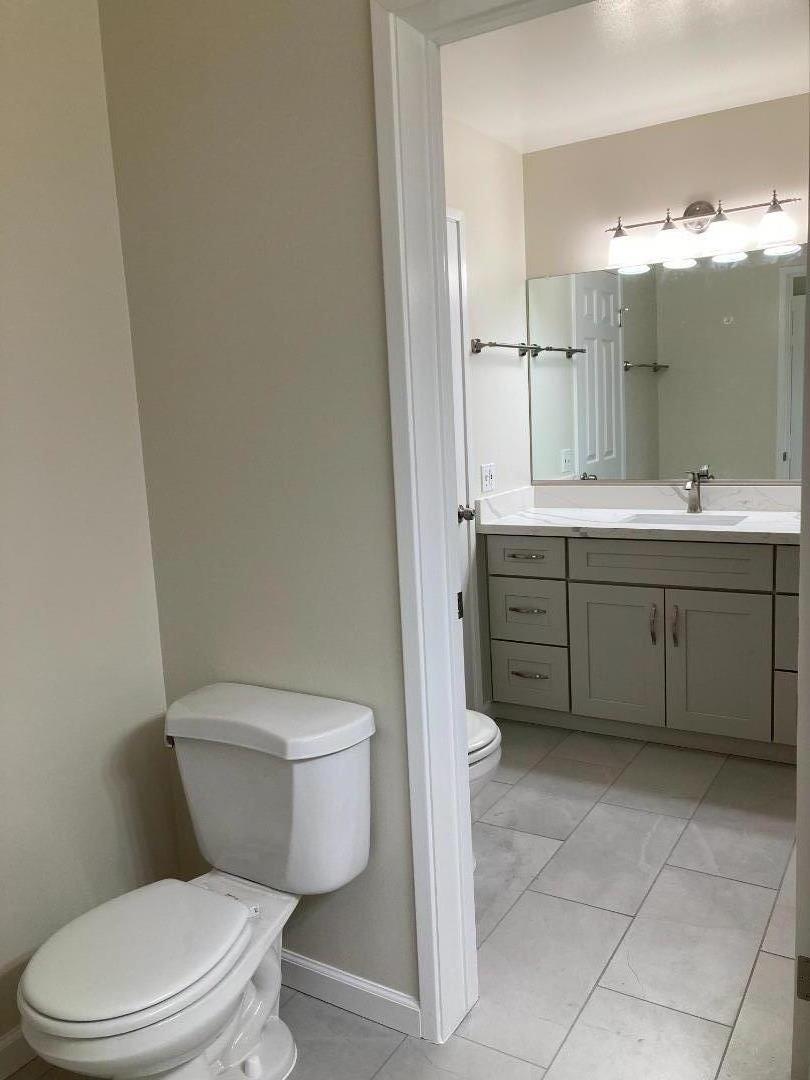 1010 Bryant Way, Unit E Sunnyvale, CA 94087 - Photo 7 of 13 a bathroom with a toilet a sink and mirror