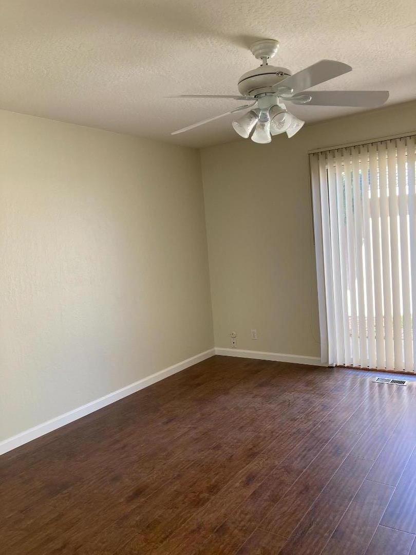 1010 Bryant Way, Unit E Sunnyvale, CA 94087 - Photo 8 of 13 a view of an empty room with wooden floor and a window