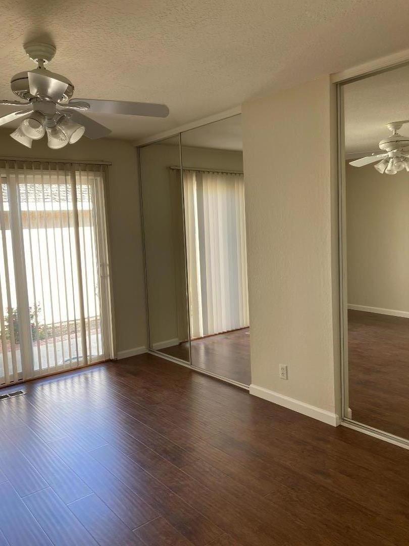 1010 Bryant Way, Unit E Sunnyvale, CA 94087 - Photo 9 of 13 an empty room with wooden floor and windows