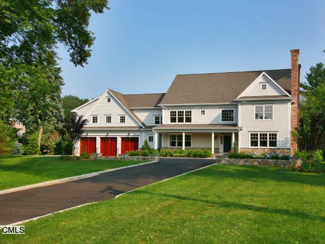 a view of large house with a big yard and large trees