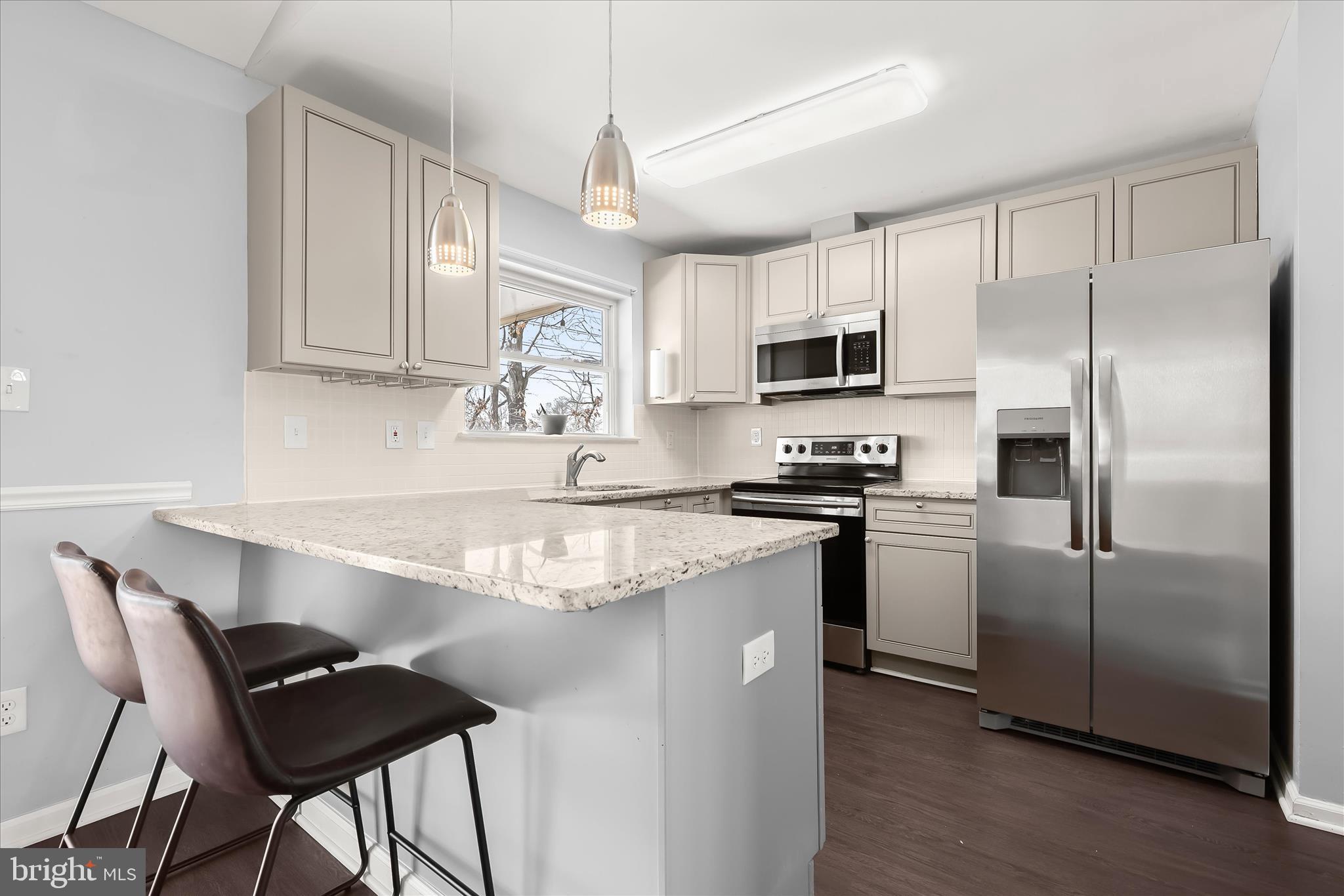 8624 Castlemill Circle Nottingham, MD 21236 - Photo 11 of 34 a kitchen with granite countertop a refrigerator stove top oven and sink